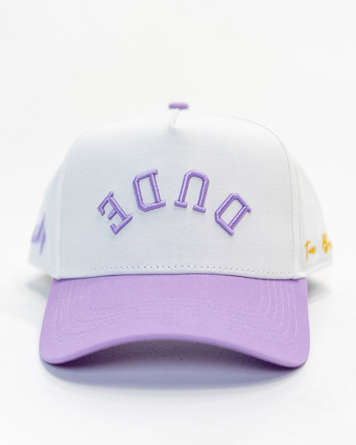 A white and purple 5 panel structured cap with 'DUDE' embroidery in purple on the front.